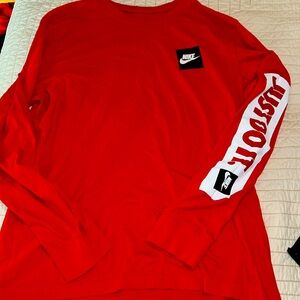 The Nike T  men’s size large 100% cotton red